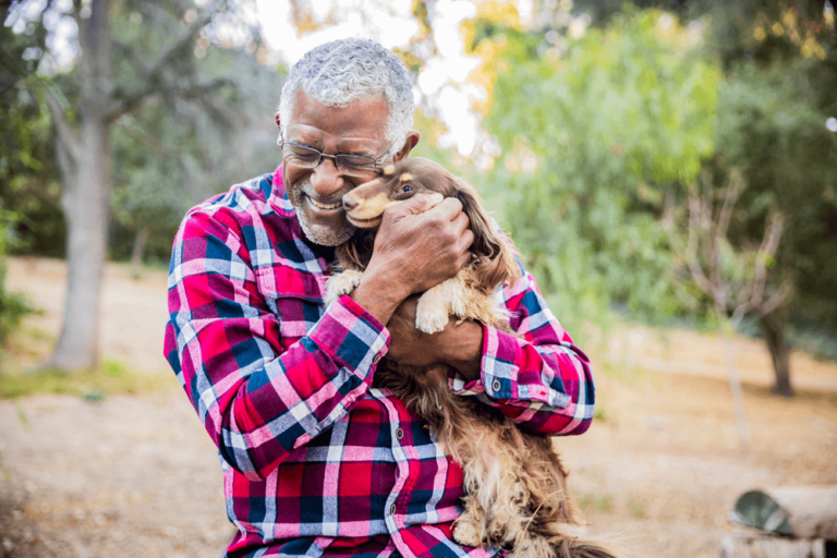 A man with his dog in a warm embrace