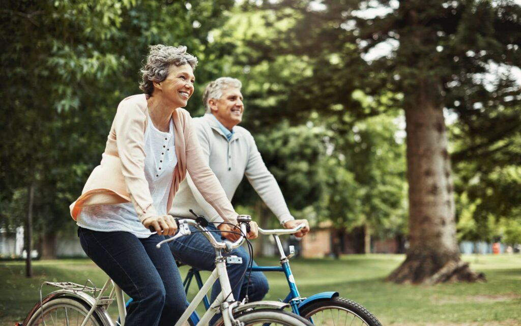 senior-living-Durham-north-carolina-1 - Bartlett Reserve - Senior Living Durham, NC A couple enjoying a bike ride in the park