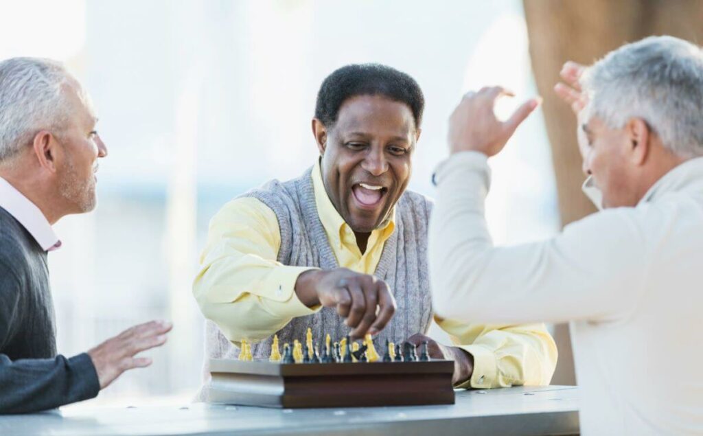 seniors playing chess at an All-Inclusive Senior Living Apartments in Durham NC
