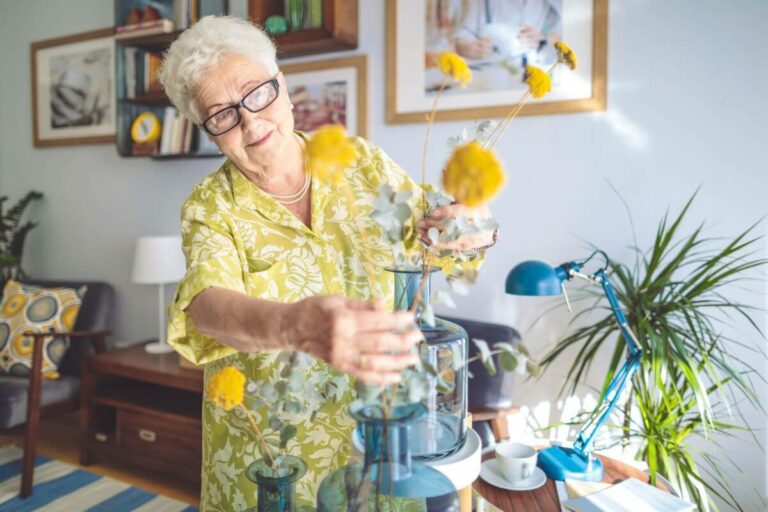 Independent Living Apartments in Durham NC with All-Included Services - Bartlett Reserve - Senior Living Durham, NC senior in apartment with flowers at a Independent Living Apartments in Durham NC with All-Included Services