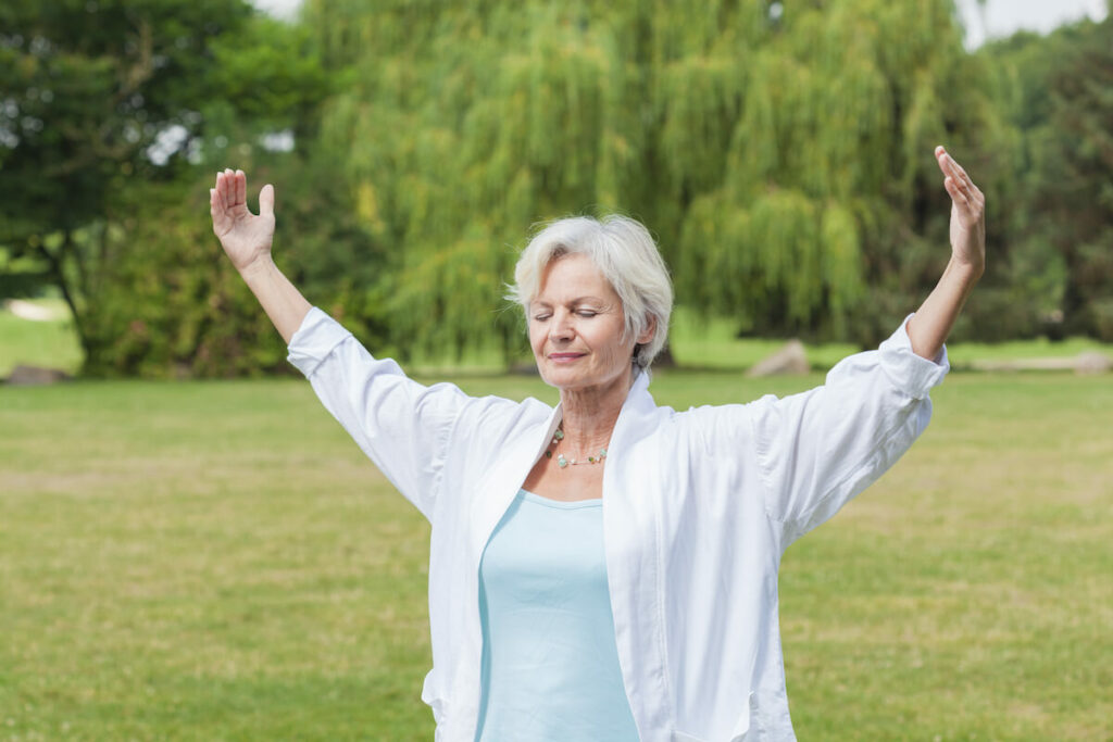 Older Woman Practicing Yoga Outdoors - Bartlett Reserve - Senior Living Durham, NC Older Woman Practicing Yoga Outdoors